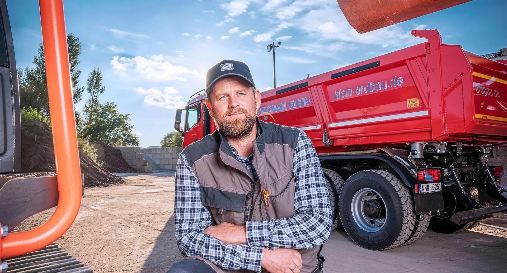 Mitarbeiter der Michael Klein GmbH vor einem Kipper-LKW mit Firmenlogo